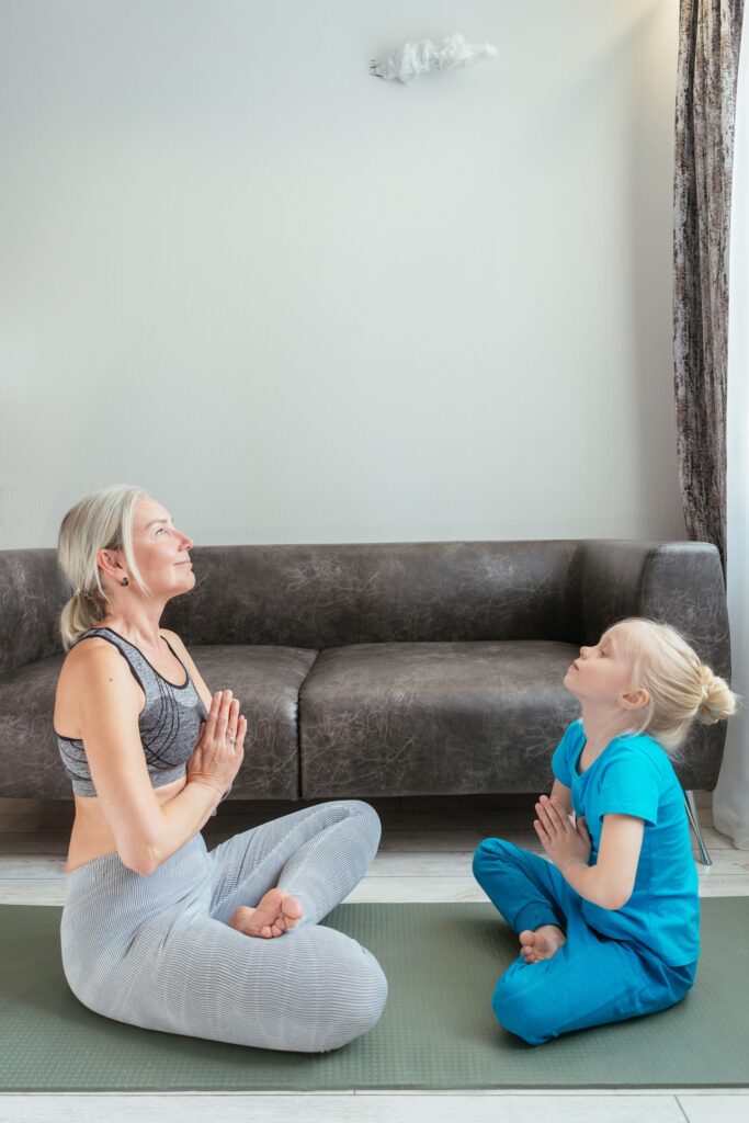 mother and daughter doing yoga poses